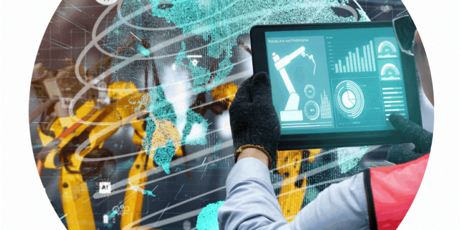 Technician uses a tablet to monitor a robotic arm in a high-tech factory with a holographic world map.